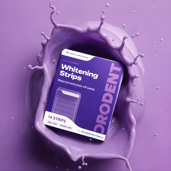 A purple box of DRODENT Whitening Strips is centered inside a glossy purple paint splash on a matching purple background. The box reads 'Whitening Strips' and '14 STRIPS'.